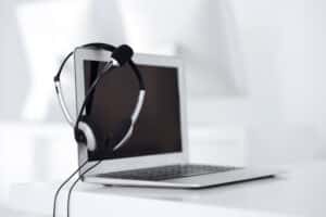a laptop with headphones on top of it